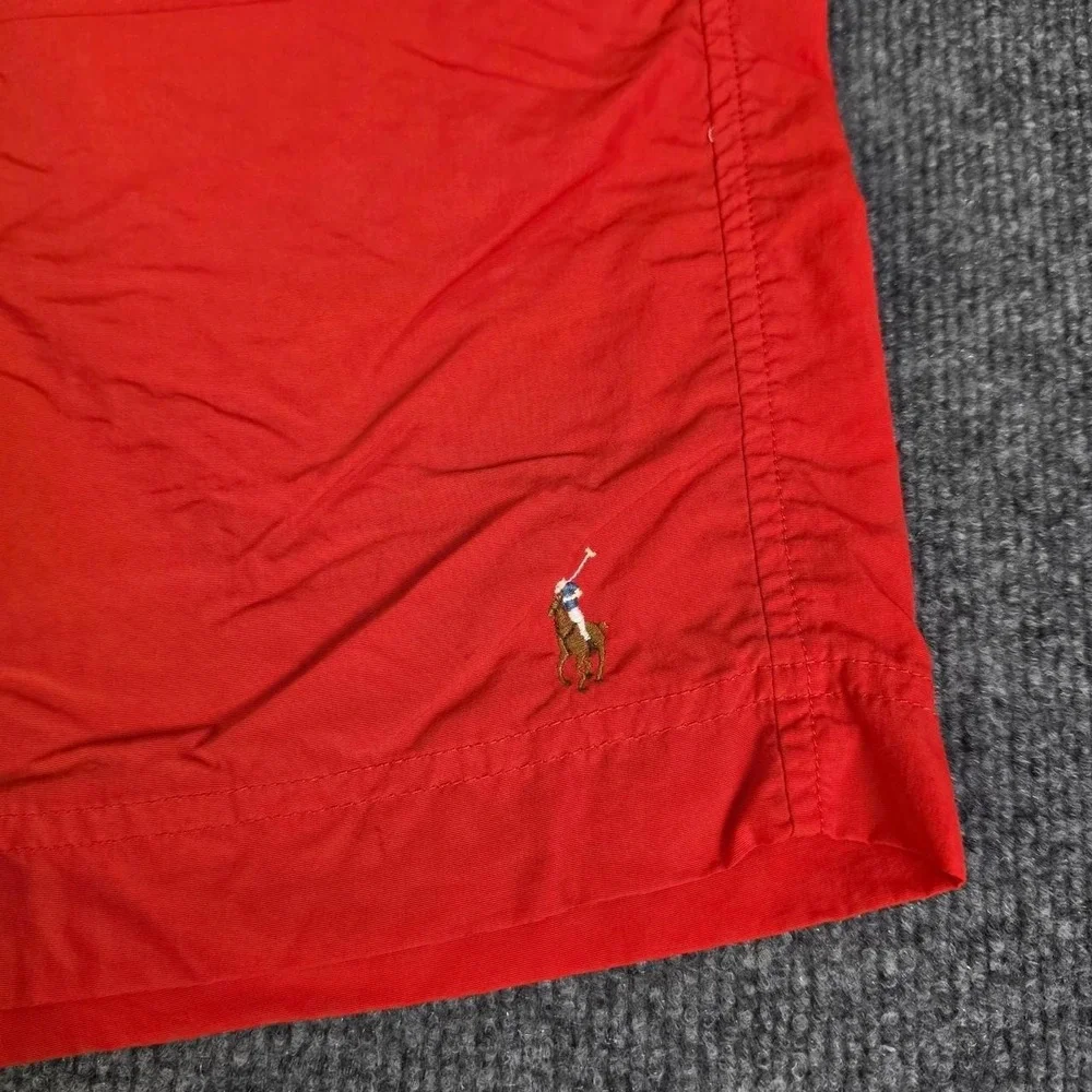 Polo Ralph Lauren orange swim shorts with blue drawstrings. Size XL.